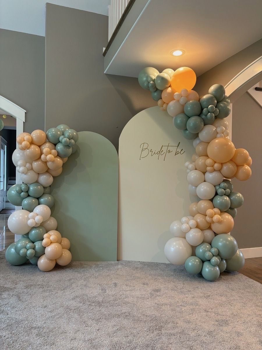 Sage, ivory and peach balloons on layered arched backdrops